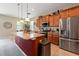 Kitchen with granite countertops, stainless steel appliances, and a spacious island with pendant lighting at 10617 Lucaya Dr, Tampa, FL 33647