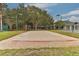Sand volleyball court surrounded by tall trees at 10617 Lucaya Dr, Tampa, FL 33647