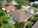 Aerial view of home with a screened-in pool, showcasing its layout and lush landscaping at 1135 Wyndham Lakes Dr, Odessa, FL 33556