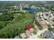 Drone view of the neighborhood showing surrounding homes, foliage, and a large lake in the distance at 1135 Wyndham Lakes Dr, Odessa, FL 33556