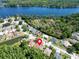 Scenic aerial view of a lovely neighborhood with mature trees, a glistening lake, and manicured lawns at 1135 Wyndham Lakes Dr, Odessa, FL 33556