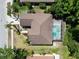 Overhead view showcasing a screened pool, mature trees, and well-maintained backyard, capturing a peaceful outdoor oasis at 1135 Wyndham Lakes Dr, Odessa, FL 33556