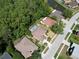 An aerial view of the property showing the home's pool, landscaping, and surrounding neighborhood at 1135 Wyndham Lakes Dr, Odessa, FL 33556