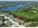 Beautiful aerial view of a lakeside community with lush green trees and well-maintained houses at 1135 Wyndham Lakes Dr, Odessa, FL 33556