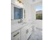 Stylish bathroom features a vanity with golden accents, contemporary finishes, and a well-lit mirror at 1135 Wyndham Lakes Dr, Odessa, FL 33556
