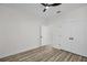 Clean, minimalist bedroom features ceiling fan, closet, door, and wood-look floors at 1135 Wyndham Lakes Dr, Odessa, FL 33556