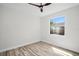 Minimalist bedroom featuring modern ceiling fan, light hardwood floors, and a bright window at 1135 Wyndham Lakes Dr, Odessa, FL 33556