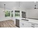 Modern kitchen boasts stainless appliances, quartz countertops, and a view of the pool at 1135 Wyndham Lakes Dr, Odessa, FL 33556
