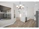Spacious living area with views of the kitchen, front entrance, and screened-in pool, offering seamless living at 1135 Wyndham Lakes Dr, Odessa, FL 33556