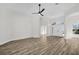 Bright and airy living room features wood floors, a ceiling fan, and views of the front entrance at 1135 Wyndham Lakes Dr, Odessa, FL 33556