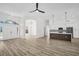 An open-concept living space showcasing the front entrance and modern kitchen with wood floors at 1135 Wyndham Lakes Dr, Odessa, FL 33556