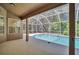 Screened-in lanai with a sparkling pool, providing a perfect outdoor living and entertaining space at 1135 Wyndham Lakes Dr, Odessa, FL 33556