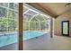 A refreshing screened-in pool with clear blue water and a covered patio area at 1135 Wyndham Lakes Dr, Odessa, FL 33556