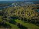 Aerial view of wooded green space behind a residential area of homes and townhomes at 11833 Castine St, New Port Richey, FL 34654