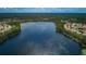 Aerial view of neighborhood lake surrounded by beautiful homes at 11833 Castine St, New Port Richey, FL 34654
