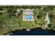 Aerial view of community amenities, including a pool, playground, lakes, and clubhouse at 11833 Castine St, New Port Richey, FL 34654