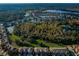 Aerial view of multi-Gathering homes, large trees, and a lake at 11833 Castine St, New Port Richey, FL 34654