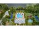 Aerial view of community amenities including pool, clubhouse, ponds, and tennis court at 11833 Castine St, New Port Richey, FL 34654