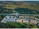 Aerial view of multi-Gathering homes, large trees, and a road with cars at 11833 Castine St, New Port Richey, FL 34654