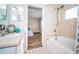 Tiled bath and shower combination with framed glass doors and bright natural light at 11833 Castine St, New Port Richey, FL 34654