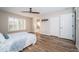 Spacious bedroom features sleek ceiling fan, wood-look flooring, and double door closets at 11833 Castine St, New Port Richey, FL 34654