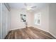 Bright bedroom featuring wood-look floors, a ceiling fan, and a window with shutter style blinds at 11833 Castine St, New Port Richey, FL 34654