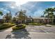 Community clubhouse with lush landscaping, trees, and accessible parking at 11833 Castine St, New Port Richey, FL 34654