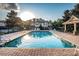View of the community pool and clubhouse with plenty of lounge chairs at 11833 Castine St, New Port Richey, FL 34654