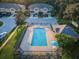 Aerial view of the community pool with lounge chairs and shade umbrella at 11833 Castine St, New Port Richey, FL 34654