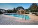 Community pool with a splash pad area for children and a covered lounging area at 11833 Castine St, New Port Richey, FL 34654