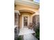 Close up front porch with stone columns, front door and chair at 11833 Castine St, New Port Richey, FL 34654