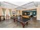 Recreational game room featuring a pool table, ample seating, and large windows for natural light at 11833 Castine St, New Port Richey, FL 34654