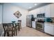Well-equipped kitchen with stainless steel appliances, white cabinetry, and a charming breakfast nook at 11833 Castine St, New Port Richey, FL 34654