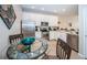 Eat-in kitchen with stainless steel appliances, white cabinets, and a decorative glass table at 11833 Castine St, New Port Richey, FL 34654