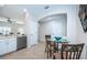 Bright kitchen features stainless steel appliances, white cabinets and a charming breakfast nook at 11833 Castine St, New Port Richey, FL 34654