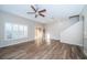 Spacious living room with wood floors, plantation shutters, and ample natural light at 11833 Castine St, New Port Richey, FL 34654