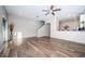 Bright living room with wood floors offers an open concept design and staircase access at 11833 Castine St, New Port Richey, FL 34654