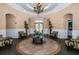 Elegant lobby with tiled floors, arched doorways, comfortable seating, and chandelier lighting at 11833 Castine St, New Port Richey, FL 34654