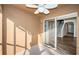 Screened patio with fan overlooking interior stairs and wood-look flooring at 11833 Castine St, New Port Richey, FL 34654
