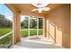Screened patio with fan overlooking green lawn and mature trees at 11833 Castine St, New Port Richey, FL 34654