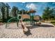 Community playground featuring slides, climbing structures, and a safe, sandy play area at 11833 Castine St, New Port Richey, FL 34654