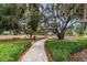 Enjoy a walk in the park on this peaceful walking path, shaded by mature trees at 11833 Castine St, New Port Richey, FL 34654