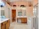 Bright bathroom featuring double sinks, bathtub, shower, and high ceilings with unique decorative elements at 12322 Hawkeye Point Pl, Riverview, FL 33578