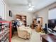 Comfortable bedroom featuring a ceiling fan, a recliner, and a built-in desk with shelving at 12322 Hawkeye Point Pl, Riverview, FL 33578