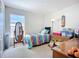 Bright bedroom with a large window, colorful bedspread, and playful decor, great for  at 12322 Hawkeye Point Pl, Riverview, FL 33578