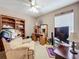 Comfortable bedroom with a ceiling fan, recliner, and built-in desk, perfect for work or relaxation at 12322 Hawkeye Point Pl, Riverview, FL 33578