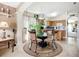 Cozy dining area with a glass table, four ornate chairs, and ample natural light streaming through the window at 12322 Hawkeye Point Pl, Riverview, FL 33578