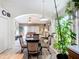 An inviting dining area with a glass table and four chairs, filled with natural light and lush greenery at 12322 Hawkeye Point Pl, Riverview, FL 33578