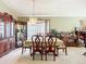 Elegant dining room with a chandelier, wood furniture, and bright, natural light at 12322 Hawkeye Point Pl, Riverview, FL 33578