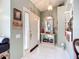 Bright entryway with white tile flooring, decorative mirror, and neutral paint at 12322 Hawkeye Point Pl, Riverview, FL 33578